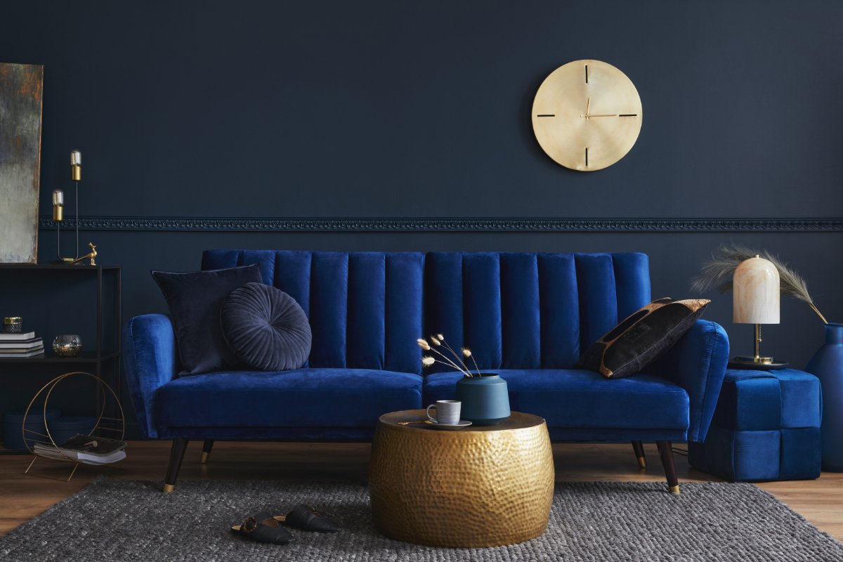 Living Room With Dark Blue Furniture and Metallic Gold Accent